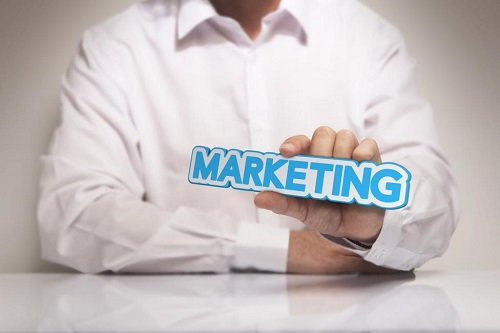 Marketing manager holding a marketing sign