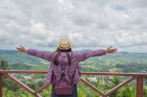 Girl with her arms spread out exploring the new country