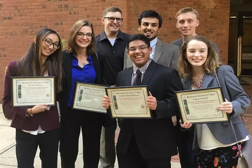 Students at Monmouth University holding certificates